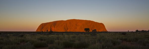 This image of Uluru as sunset was taken from the popular viewing area in the Uluru-Kata Tjuta National Park and UNESCO World Heritage site.